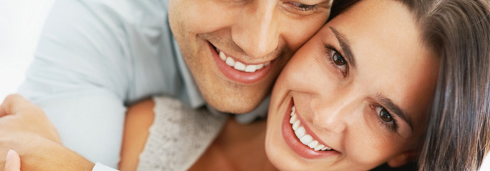 Smiling couple hugging tightly, illustrating family wellness achieved by choosing a trusted Medway chiropractic office for overall health.