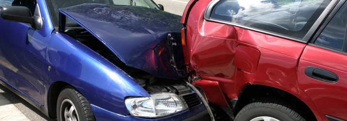 Blue car crashing into the rear end of a red car, illustrating injury advice and tips from a Medway chiropractor.